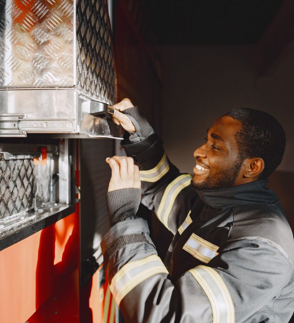 Arfican fireman in a uniform. Man prepare to work.